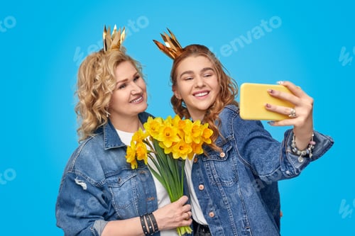 Preview: Mother and daughter taking selfie during birthday celebration
