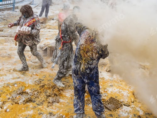 Preview: Ibi, Spain - December, 28 2018: People throwing eggs and flour at each other
