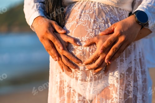 Preview: A pregnant woman is holding her stomach with her hands