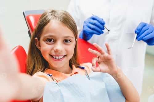 Preview: Girl showing okay gesture taking selfie vlogging while healing teeth with dentist orthodontist.