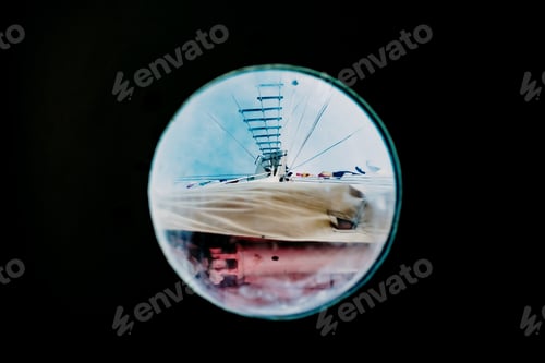 Preview: Ship moored to port seen through from inside the porthole of a ship.