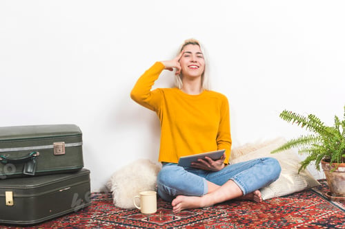 Preview: Woman Relaxing on a Rug with Tablet