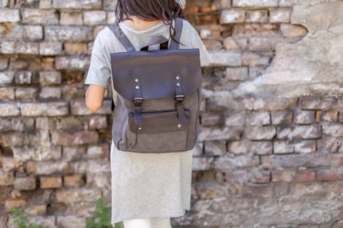 Preview: Back of woman with gray canvas backpack