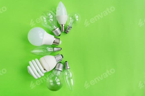 Preview: A set of different types of LED lamps isolated on a green background. Energy-saving lamps.