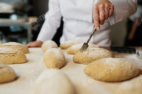 Preview: Woman baker decorating traditional yeast buns