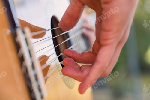 Preview: Close-up of the musician's playing hands. The guitarist plays the guitar.