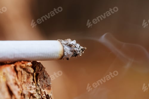 Preview: Cigarette with smoke on wooden background Cigarette smoking