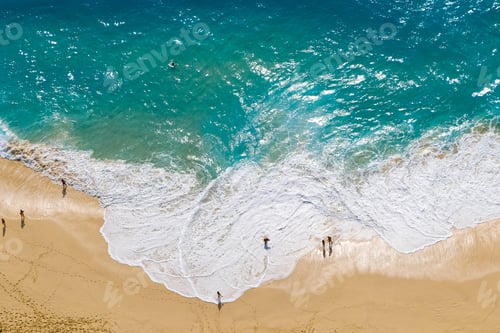 Preview: Top-Down View of Beachgoers on Sandy Shore with Crashing Waves