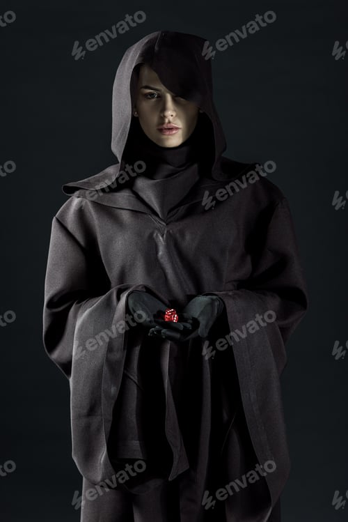 Preview: woman in death costume holding dice isolated on black