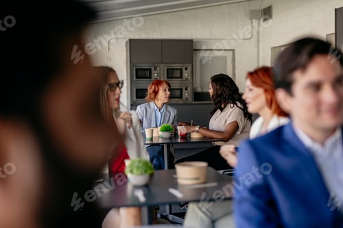 Preview: colleagues on their break time share time in the kitchen common room