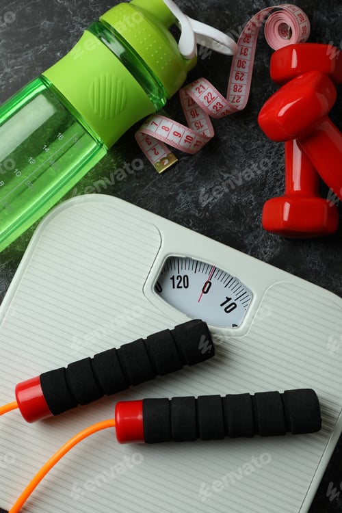 Preview: Weight loss accessories on black smoky background, top view