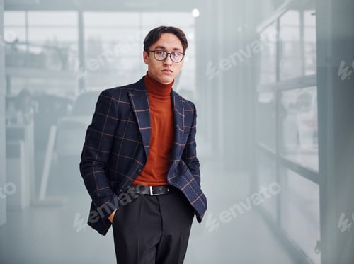 Preview: Young business man in luxury suit and formal clothes posing for the camera indoors