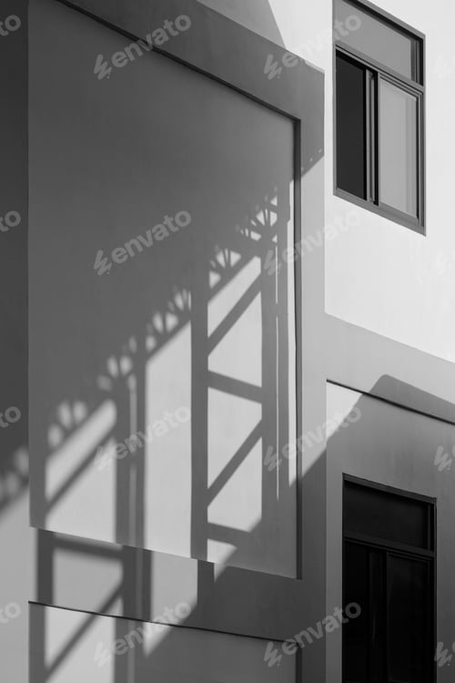 Preview: Light and shadow of metal column on industrial office building wall in black and white style