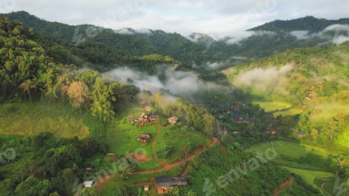 Preview: Aerial view from drone of the rural village in the mountains on foggy day