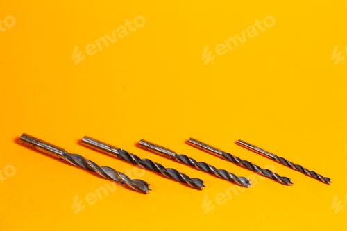 Preview: Drills for wood of different sizes for a drill on an orange background. Construction tool