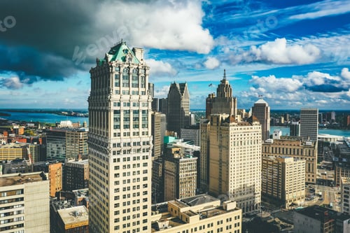 Preview: Cityscape of Detroit under the sunlight and a dark cloudy sky at daytime in Michigan in the US