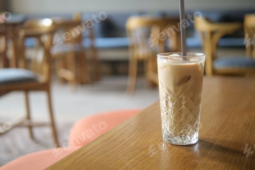 Preview: Refreshing iced drink on a wooden table in a cozy cafe