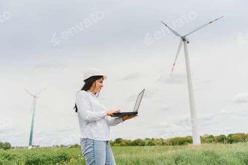 Preview: Environmental engineer with a laptop at wind farm