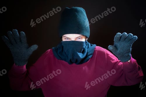 Preview: male gangster wear dark mask fight with fists on dark background isolated b