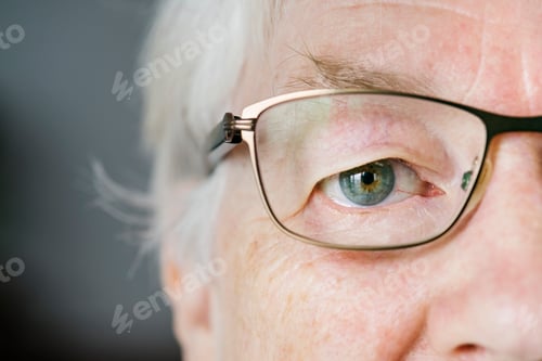 Preview: Portrait of white elderly woman closeup on eyes wearing specatac