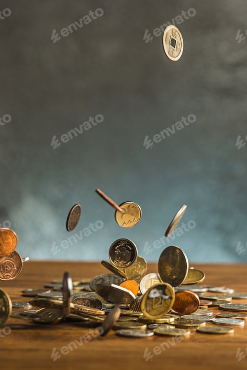 Preview: The silver and golden coins and falling coins on wooden background