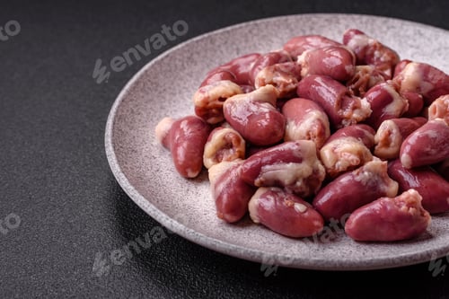 Preview: Raw chicken hearts with salt, spices and herbs