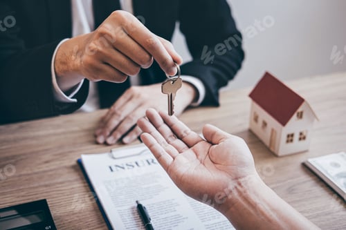 Preview: Estate agent giving house keys to client after signing agreement contract real estate with approved