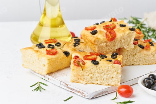 Preview: Sliced pieces of focaccia with tomatoes, olives and rosemary. Traditional Italian flat bread.