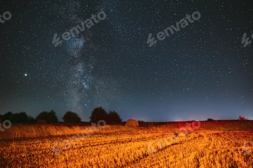 Preview: Milky Way Galaxy In Night Starry Sky Above Haystack In Summer Agricultural Field. Night Stars Above