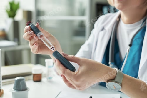Preview: Middle Aged Caucasian Female Doctor Preparing Insulin Injection for Patient