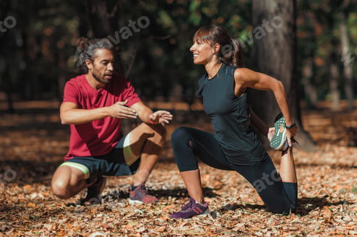 Preview: Young Couple stretching after training in the park