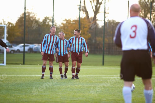 Preview: Football players forming wall to defend free kick