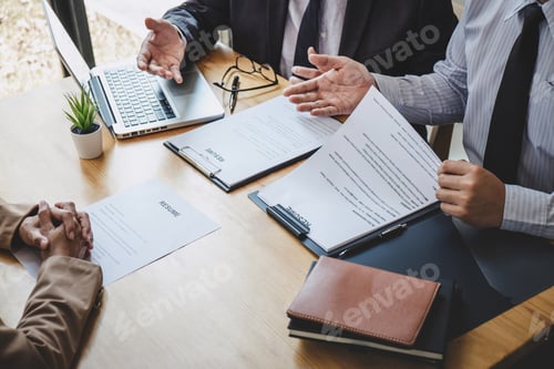 Preview: Two selection committee manager reading a resume during a job interview