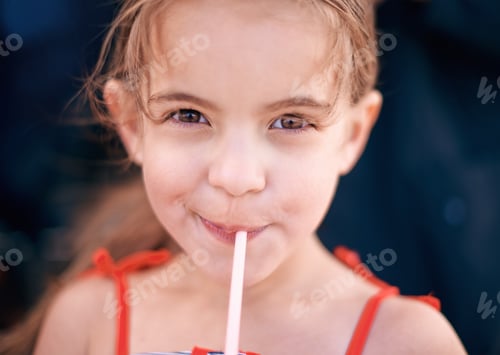 Preview: Mmm delicious. Shot of a little girl drinking a beverage outdoors.