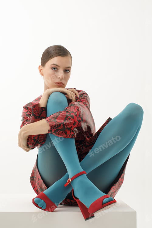Preview: fashion model in red dress and blue tights sitting