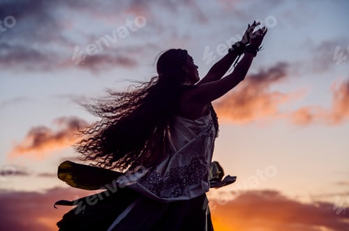 Preview: Silhouetted woman hula dancing wearing traditional costume at dusk, Maui, Hawaii, USA
