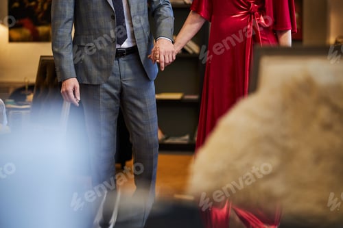 Preview: Stylish man and gorgeous woman walking hand in hand