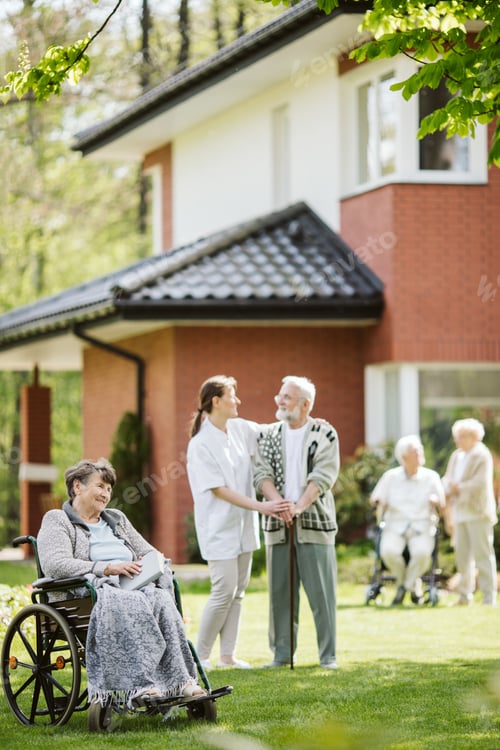 Preview: Happy group of elder people and caregiver in the garden
