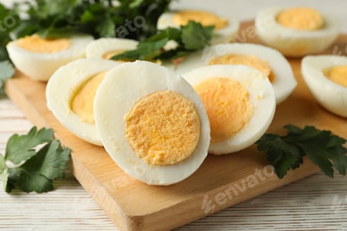 Preview: Board with boiled eggs on white wooden background