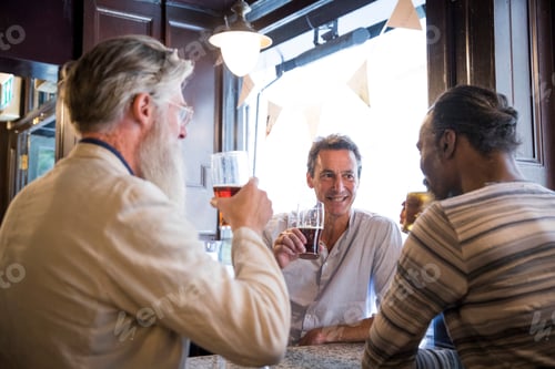 Preview: Three mature men, sitting together in pub, talking