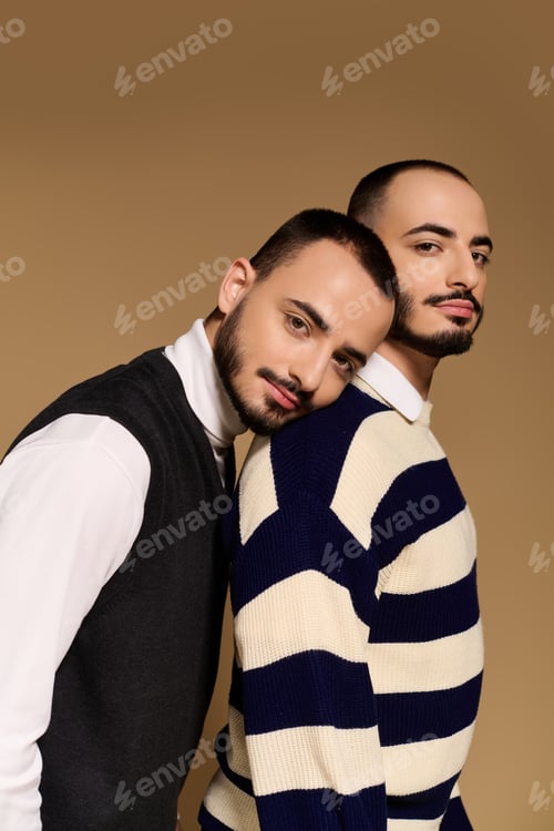 Preview: Twins showcase stylish attire and brotherly bond in a modern studio setting