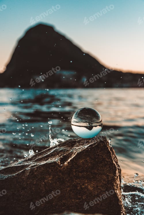 Preview: Close-up of crystal ball with reflection in water