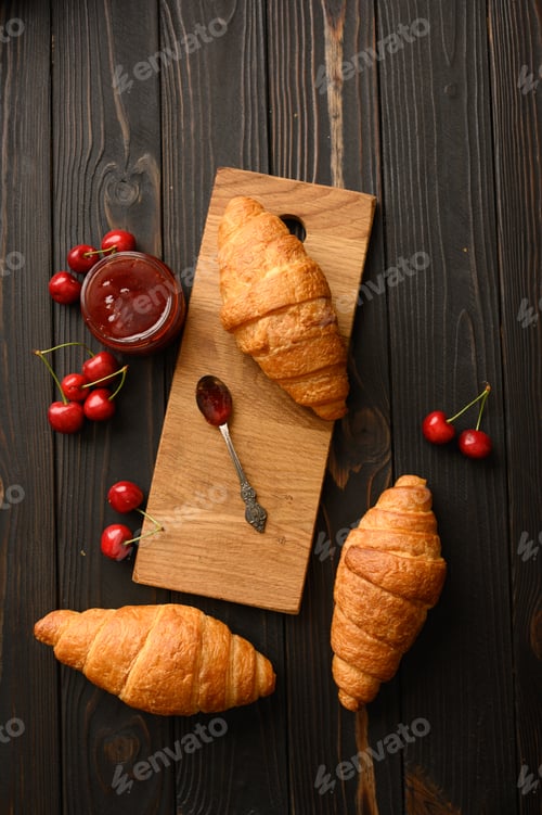 Preview: Tasty and delicious croissants with jam on a wooden table