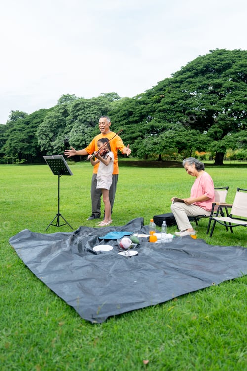 Preview: Vertical image of Asian senior man stand in the back of little girl who play song with violin