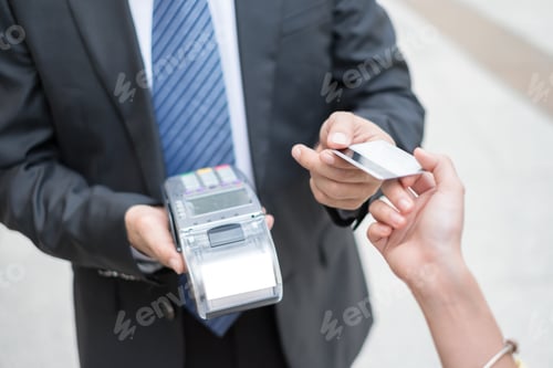 Preview: Hand paying credit card with payment terminal with cashier man