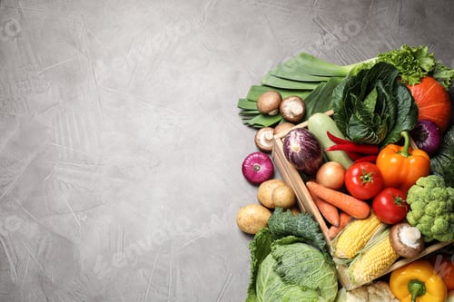 Preview: Flat lay composition with fresh vegetables on grey table, space for text