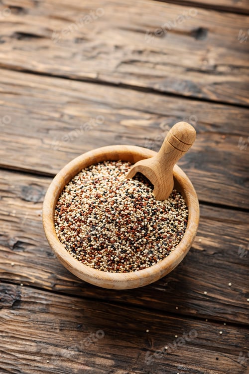 Wooden Bowl Filled with Quinoa and Wooden Spoon