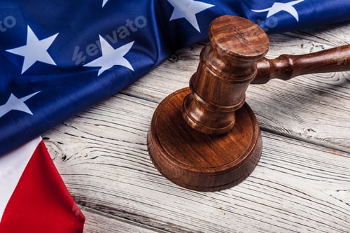Preview: Wooden gavel and USA flag on table close up