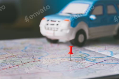 Preview: Toy car and push pin on the map. Travelling concept. Shallow depth of field.