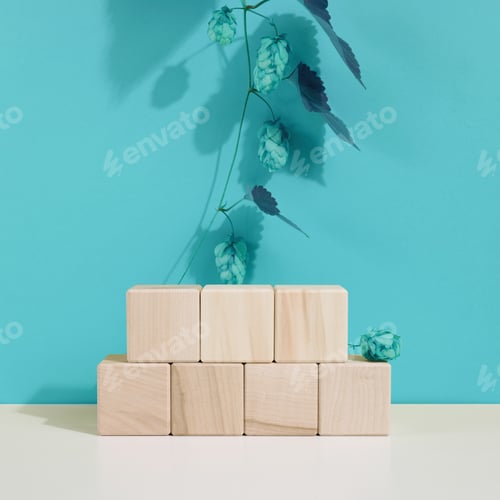 Preview: Podium from wooden cubes and a branch with leaves. Stage for the demonstration of cosmetic products
